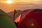 Hiking tents and walking stick at the sunset