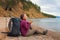 Hiking tourism adventure. Backpacker woman resting after hiking looking at beautiful view. Hiker girl lady tourist with