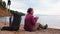 Hiking tourism adventure. Backpacker woman resting after hiking looking at beautiful view. Hiker girl lady tourist with