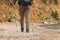 Hiking tourism adventure. Unrecognizable hiker girl tourist with backpack walking near lake. Backpacker woman feet and