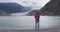 Hiking tourist on Alaska travel taking photo of glacier