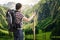 Hiking tourist with backpack from behind. Alps in background.