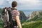 Hiking tourist with backpack from behind in mountains in Croatia near Omis city.