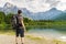 Hiking tourist from behind and lake near Alps in Almsee in Austria