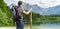 Hiking tourist from behind and lake near Alps in Almsee in Austria. Panoramic photo
