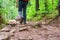 Hiking tourists wearing backpacks outdoors trekking in forest. hiker man with shoe covered in mud taken walking in rain forest.