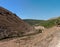 Hiking track between brown Mediterranean hills