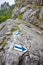 Hiking trail blue paint arrow marking on a rock