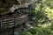 Hiking trail boardwalk under rocky overhang