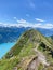 Hiking trail in Switzerland with Swiss flag on the top of a mountain