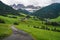 Hiking trail to St Magdalena church in Val di Funes valley, Dolomites, Italy. Furchetta and Sass Rigais mountain peaks