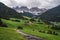 Hiking trail to St Magdalena church in Val di Funes valley, Dolomites, Italy. Furchetta and Sass Rigais mountain peaks