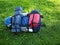 Hiking and travel backpack and gear on green grass