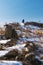 Hiking up the mountain peak in winter, winter vertical landscape