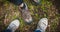 Hiking or walking shoes of two female travellers standing in the forest.