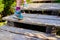 Hiking woman with boots on wooden trail, outdoors activity