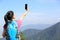 Hiking woman taking photo with phone