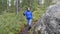 Hiking Woman Trekking in Forest. Front View of Young Mixed Race Girl Hiker Walking on Trek with Backpack and Looking