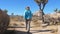Hiking Women In The Mojave Desert, Among The Cacti, Joshua Trees And Stones