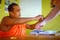 Hikkaduwa, Sri Lanka - 31 January 2017: Buddhist monk Binds a white thread, a string, a charm to the hand