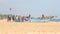 HIKKADUWA, SRI LANKA - FEBRUARY 2014: View of locals standing and sitting on boat on Hikkaduwa beach. Hikkaduwa is famous for its