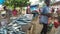 HIKKADUWA, SRI LANKA - MARCH 2014: Fresh fish on the table at market in Sri Lanka, customers passing by.