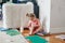 Hilarious cute baby girl drawing with marker her body legs. Toddler girl child playing at home. Authentic candid childhood