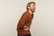 Hilarious laughter. Portrait of amused man with beard wearing sweatshirt holding belly and laughing out loud