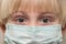 Ð¡hild face in medical mask, close up. Frightened eyes of child in protective face mask