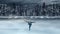 Hild figure skater on winter lake background