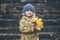 Ð¡hild girl in warm jacket and hat in the autumn in the Park