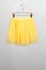 hildren skirt yellow hanger on gray background