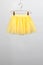 hildren skirt yellow hanger on gray background