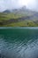 Hill and colorful water at Bachalpsee near First, Switzerland