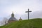 Hill with a cross and cupola with golden statue of the chapel of our lady of Oudenberg