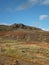 Hill in the Haukadalur Valley geothermal area in Iceland with high blue sky