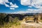 Hill landscape view with bench and dramatic sky