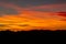 Hill silhouettes under a cloudy sky during a breathtaking sunset in Patagonia, Argentina