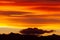 Hill silhouettes under a cloudy sky during a breathtaking sunset in Patagonia, Argentina