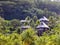 Hill slope in a rainforest and forgotten wooden huts