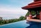 Hill top Villa infinity edge pool with seascape and blue sky