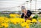 Hill-tribe girl are collection yellow flowers in the garden with smiling and hold the basket on left hand