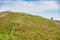 Hill walkers stroll past Worcestershire Beacon at Malvern Hills, on a summer morn