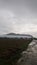 hills and cornfields with cloudy blue sky