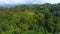 Hills covered in lush greenery in Batumi Botanical Garden railroad running along