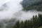 The hills of the Dolomites covered with dense fog