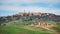 Hills of meadows below the medieval village of Pienza in Tuscany