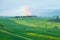 Hills with rainbow.  Val d`Orcia landscape in spring. Hills of Tuscany. Cypresses, hills, yellow rapeseed fields and green meadow