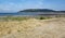 Hills rise rise up behind the stoney beach at Porlock Weir in Somerset, UK