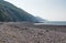 Hills rise rise up behind the stoney beach at Porlock Weir in Somerset, UK